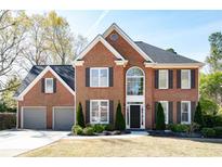 Charming two-story brick home with a manicured front lawn and a two-car garage at 2996 Bea Mar Dr, Marietta, GA 30062