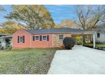 Charming home featuring vinyl siding, brick accents, and a covered carport with a freshly paved driveway at 5164-0 Phillips Dr, Forest Park, GA 30297