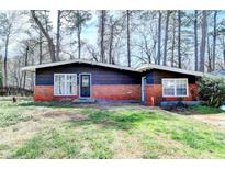 Cozy single-story home with brick accents and a well-maintained front yard, perfect for first-time buyers at 3007 Pasadena Dr, Decatur, GA 30032