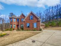 Charming two-story brick home with well-maintained landscaping and a spacious driveway at 2470 Bridle Bridge Trl, Cumming, GA 30040