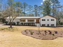 Charming single-story home with white brick and inviting curb appeal at 4562 Anderson Livsey Ln, Snellville, GA 30039