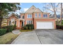 Charming two-story brick home with attached two-car garage and well-manicured landscaping at 5071 Vinings Estates Se Ct, Mableton, GA 30126