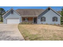 Charming single-Gathering home featuring a well-manicured lawn and attached garage at 45 Buckeye Cir, Covington, GA 30016