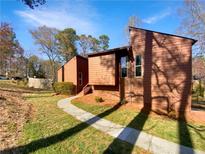 Charming two-story home with neutral siding, a well-manicured lawn and a stone pathway at 2111 Cedar Forks Dr, Marietta, GA 30062