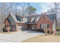 Charming brick home with a well-manicured lawn and an attached two-car garage at 1765 Dew Pl, Marietta, GA 30064