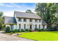 Stately two-story home with a manicured lawn, beautiful landscaping, and traditional architectural details at 3200 Farmington, Vinings, GA 30339