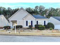 Charming single-Gathering home featuring well-maintained landscaping, a symmetrical design, and inviting curb appeal at 3775 Pine Village Pl, Loganville, GA 30052