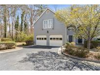 Charming home with two-car garage, mature trees, and well-maintained landscaping at 3923 Ashford Lake Ne Ct, Brookhaven, GA 30319