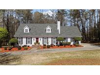 Charming single-story home with white siding, black shutters, and a well-manicured front yard at 4053 Thompson Mill Rd, Buford, GA 30519