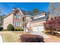 Beautiful brick home with a two-car garage, well-maintained landscaping, and a classic architectural design at 120 Windsor Cv, Atlanta, GA 30328