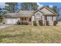 Charming ranch-style home with a manicured lawn, welcoming front porch, and attached two-car garage at 170 Double D Rd, Temple, GA 30179