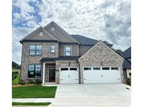Beautiful two story home features a two-car garage and a well-manicured lawn at 4190 Hosch Reserve Dr, Buford, GA 30519