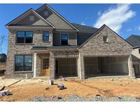 New two-story brick home featuring a large 3-car garage and stylish architectural details at 4190 Hosch Reserve Dr, Buford, GA 30519