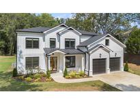 Charming new construction two-story home featuring white siding, black trim and a two-car garage at 396 Academy St, Alpharetta, GA 30009