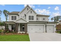 Beautiful two-story home with a three-car garage and a welcoming front porch at 444 Lower Shoreline Ct Sw, Marietta, GA 30064