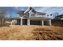 Charming gray two-story home with a spacious three-car garage on a picturesque lot at 444 Lower Shoreline Ct Sw, Marietta, GA 30064