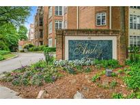 The Ansley Terrace sign surrounded by colorful flowers and manicured landscaping at 175 15Th Ne St # 410, Atlanta, GA 30309
