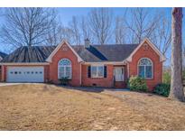Charming brick home features a two-car garage and landscaped front yard at 60 Rodney Way, Covington, GA 30016