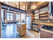 Modern kitchen features stainless steel appliances, mosaic backsplash, and mobile island at 170 Boulevard Se # 421 H, Atlanta, GA 30312