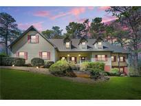 Charming two-story home featuring dormer windows, a welcoming front porch, and a well-maintained lawn at 2051 E Piedmont Rd, Marietta, GA 30062