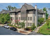 Beautiful townhome featuring a brick facade, manicured landscaping, and a private street at 6596 Aria Village Dr # 642, Atlanta, GA 30328