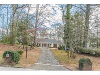 Traditional brick home with a long driveway and a well-maintained front yard landscape at 3390 Somerset Sw Trl, Atlanta, GA 30331