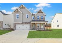 Charming two-story home with a two-car garage, brick accents, and a beautifully landscaped front yard at 4212 Adler Cir, Buford, GA 30519