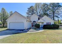Charming single-story home with a well-maintained lawn and a two-car garage at 4652 Huff Park Ct, Snellville, GA 30039