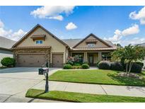 Charming home featuring a manicured lawn, two-car garage, and classic architectural details at 110 Mountain Laurel Ct, Canton, GA 30114