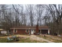 Quaint brick single-story home featuring mature trees, a lawn, and inviting front entrance at 111 Oak Grove Rd, Temple, GA 30179