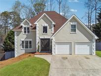 Charming two-story home featuring a manicured lawn, double garage, and a classic facade at 708 Larkspur Nw Blvd, Acworth, GA 30102