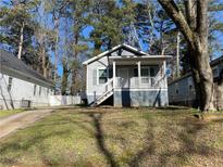 Charming home with a covered front porch and well-maintained lawn at 2938 Palm Dr, Atlanta, GA 30344