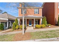 Charming two-story brick home with covered front porch and well-manicured landscaping at 4121 N Swann St, Covington, GA 30014