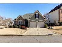 Charming home with a two-car garage, stone accents, manicured lawn, and inviting curb appeal at 2250 Snug Ne Hbr, Marietta, GA 30066