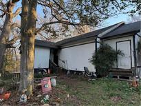 Exterior view of the home with an unkempt yard and mature trees at 2473 Hiram Sudie Rd, Hiram, GA 30141