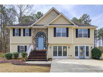 Charming two-story home with stone accents, a light blue front door, and a well-manicured lawn at 3835 Annandale Ln, Suwanee, GA 30024