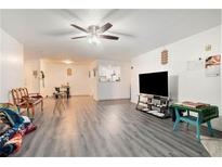 Inviting living room featuring gray laminate flooring and a ceiling fan at 417 Ridge Dr, Clarkston, GA 30021