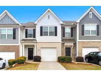 Charming townhome featuring a brick facade, single car garage and manicured landscaping at 5634 Union Pointe Dr, Union City, GA 30291