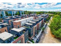 Contemporary townhome community featuring brick and modern siding, rooftop terraces, and lush landscaping at 1239 Chelsea Nw Cir, Atlanta, GA 30318