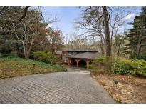 Stately home with a brick porte cochere, a cobblestone drive, and mature landscaping in a wooded setting at 2544 Brookdale Nw Dr, Atlanta, GA 30305