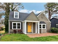 Charming home featuring a bright yellow front door, a brick walkway, and well-manicured lawn at 2654 Jefferson Ter, Atlanta, GA 30344