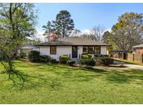 Charming single-story home with a well-maintained lawn and mature landscaping, perfect for suburban living at 863 Birch St, Forest Park, GA 30297