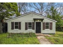 Quaint, single-story home featuring light green siding, dark shutters, and a simple covered porch at 3020 Harold Se Ave, Atlanta, GA 30316