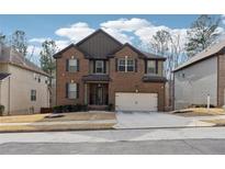 Charming two-story brick home with a well-maintained lawn and attached two-car garage at 3725 Sycamore Bnd, Decatur, GA 30034