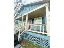 Inviting home featuring a covered porch, wood trim and a cozy aesthetic at 971 Martin Se St, Atlanta, GA 30315