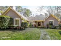 Charming single-story home with lush landscaping and a welcoming front entrance at 4751 Bill Cheek Rd, Auburn, GA 30011