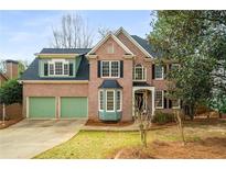 Charming brick two-story home with well-manicured lawn and a two-car garage at 351 Woodbrook Crst, Canton, GA 30114