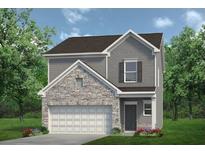 Charming two-story home with stone accents, gray siding, a two-car garage and manicured front lawn at 712 Shetland Trl, Cartersville, GA 30121