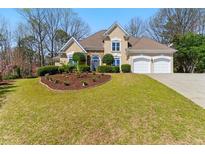 Beautiful two-story home with a manicured lawn, two-car garage, and arched entryway at 4441 Langdon Se Walk, Smyrna, GA 30080