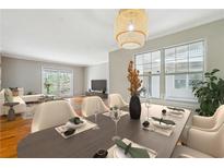 Inviting dining area with modern lighting and an open layout to the living room at 1150 Collier Nw Rd # J11, Atlanta, GA 30318